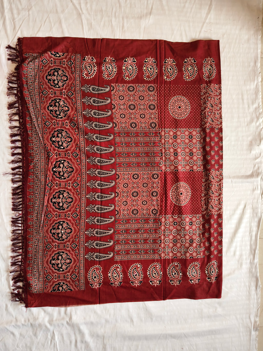 Traditional Ajrak dupatta flat lay with tassels