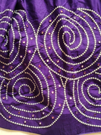 Close-up of purple spiral embroidery and mirror work
