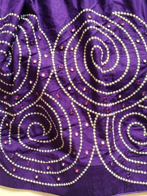 Close-up of purple spiral embroidery and mirror work