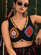 Close-up of multicolour motifs and gold coin trim