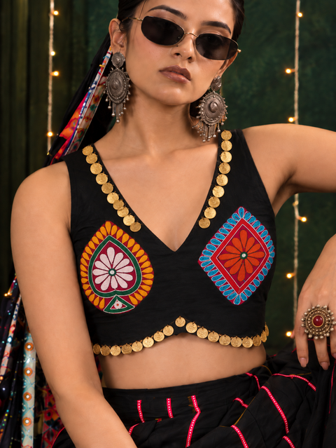 Close-up of multicolour motifs and gold coin trim