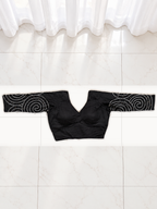 Upright back view of black spiral mirror work blouse