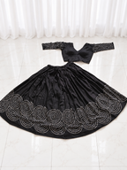 Black spiral mirror work chaniya choli set laid flat