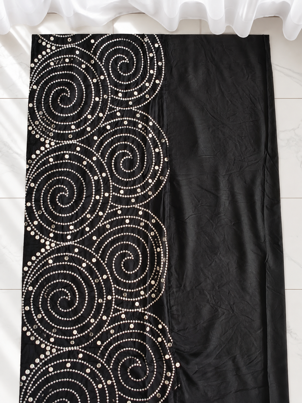 Black spiral mirror work fabric close view