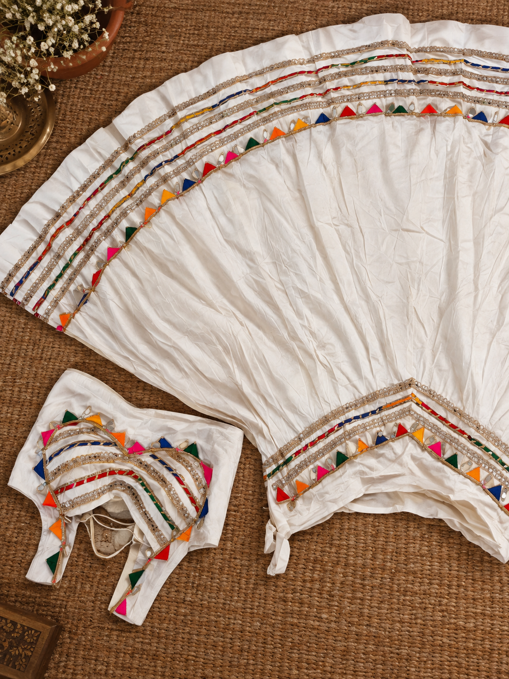 White lehenga mirror and cowrie detail