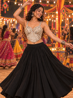 Woman wearing champagne mirror work corset Navratri blouse styled with black lehenga