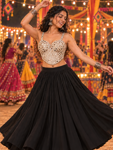 Woman wearing champagne mirror work corset Navratri blouse styled with black lehenga