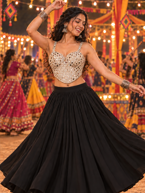 Woman wearing champagne mirror work corset Navratri blouse styled with black lehenga