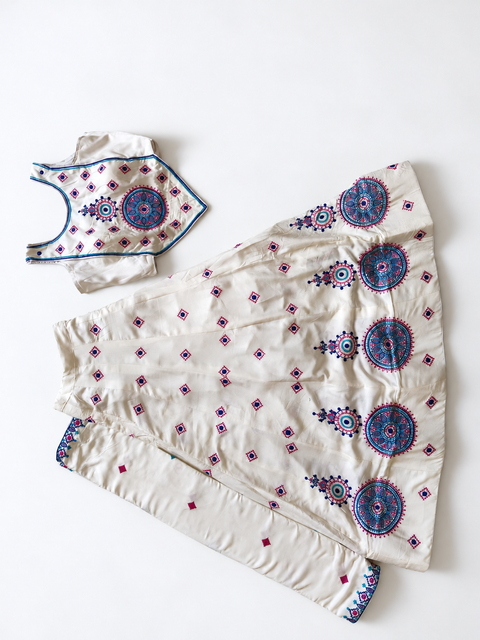 Ivory chaniya choli flat lay on white floor