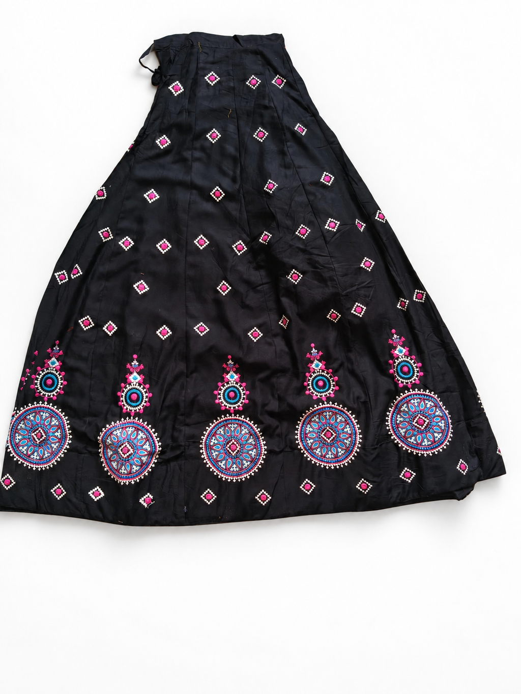Black embroidered ghagara on white floor