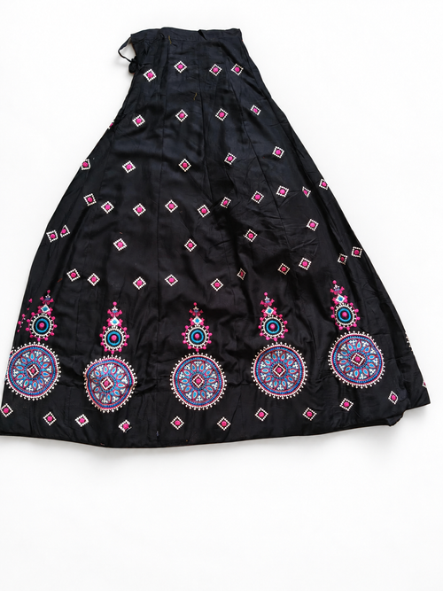 Black embroidered ghagara on white floor