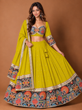Model wearing yellow mirror work Navratri chaniya choli