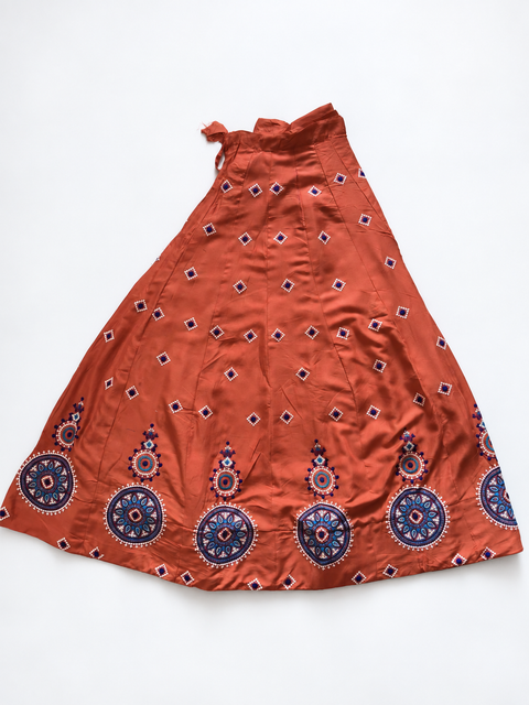 Rust orange embroidered ghagara flat lay