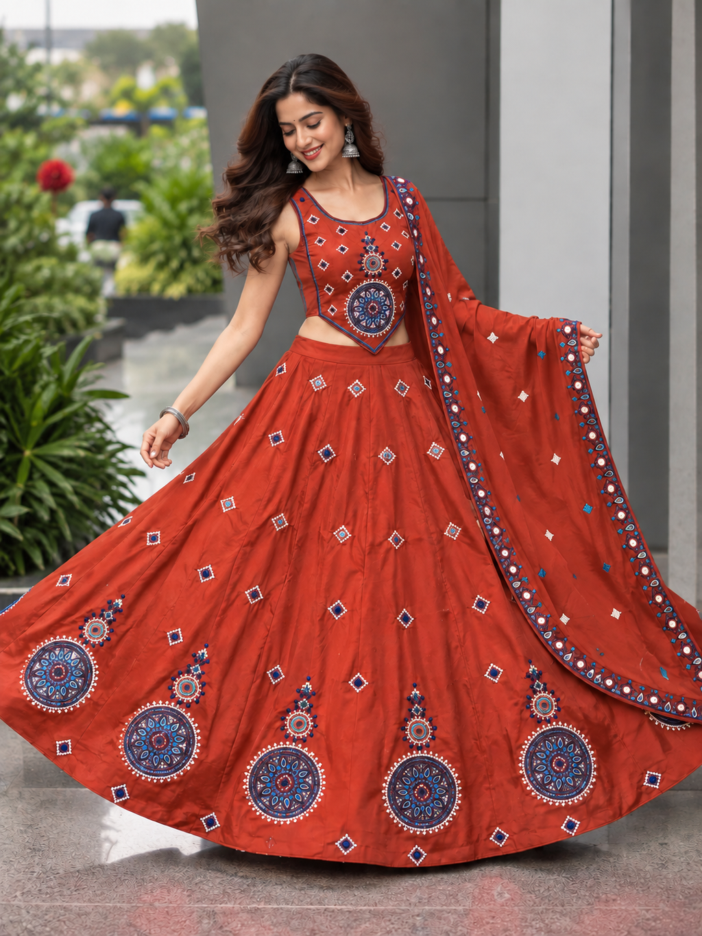 Rust orange embroidered chaniya choli on model, front view