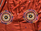 Rust orange lehenga circular motif details
