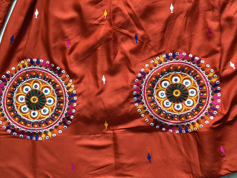 Rust orange lehenga circular motif details