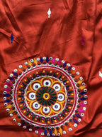 Circular embroidered mirror-work motif close-up
