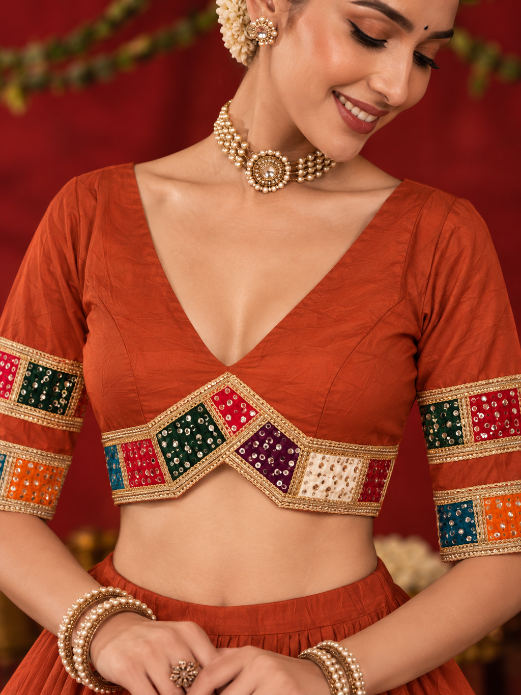 Rust orange choli mirror-work detail