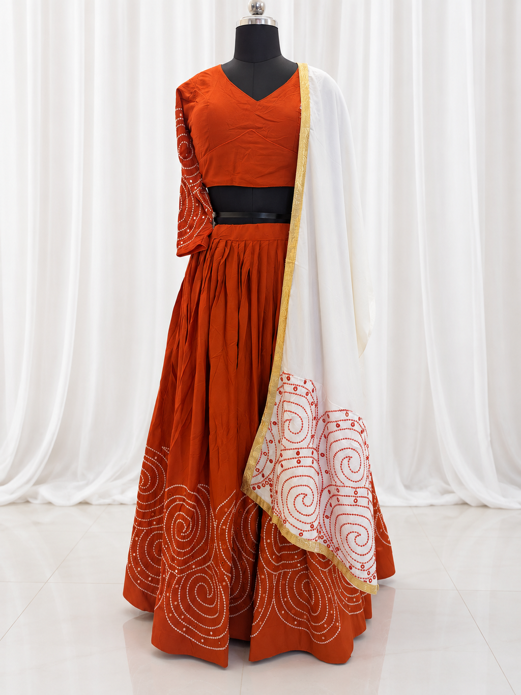Rust orange chaniya choli and white dupatta front view