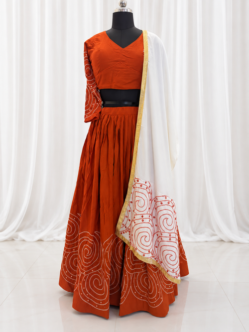 Rust orange chaniya choli and white dupatta front view