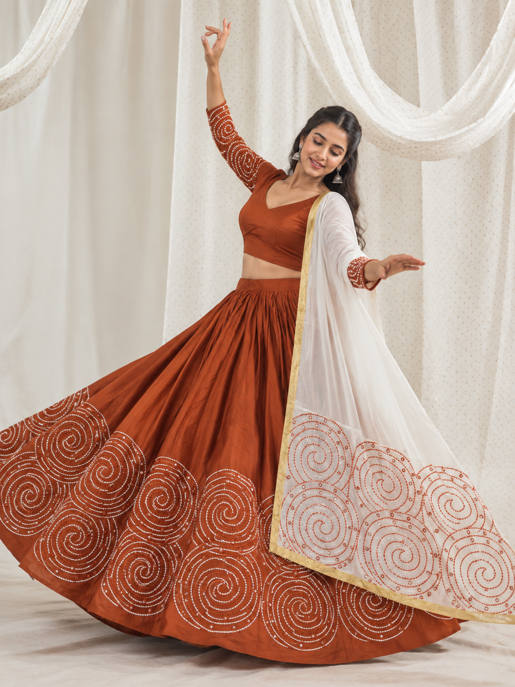 Rust orange spiral embroidered chaniya choli set on model