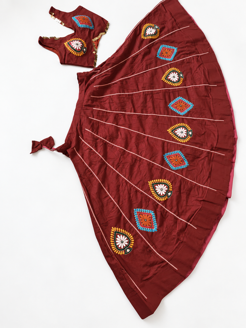Full maroon blouse and embroidered ghagara flat lay
